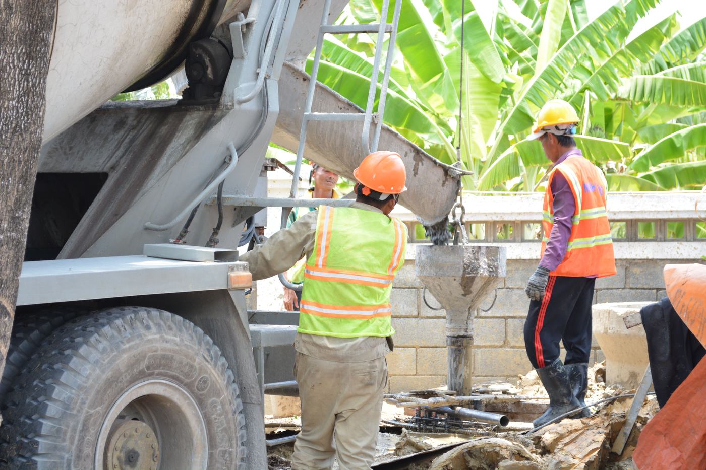 Crew discharging concrete from a mixer truck on site